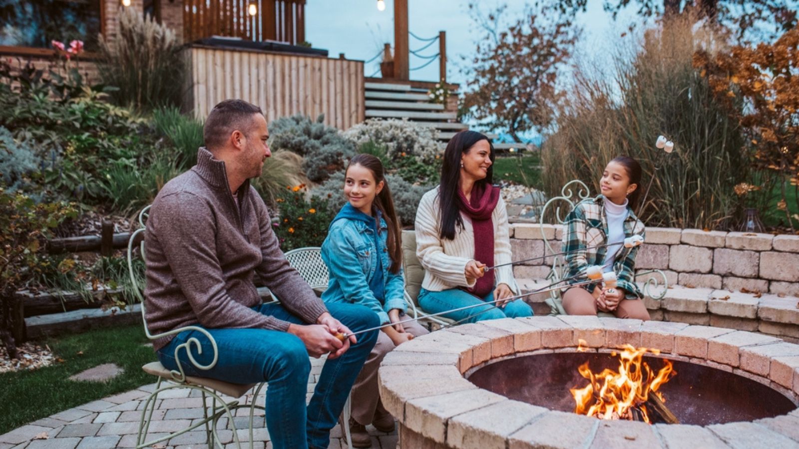 family toasting marshmallows at firepit