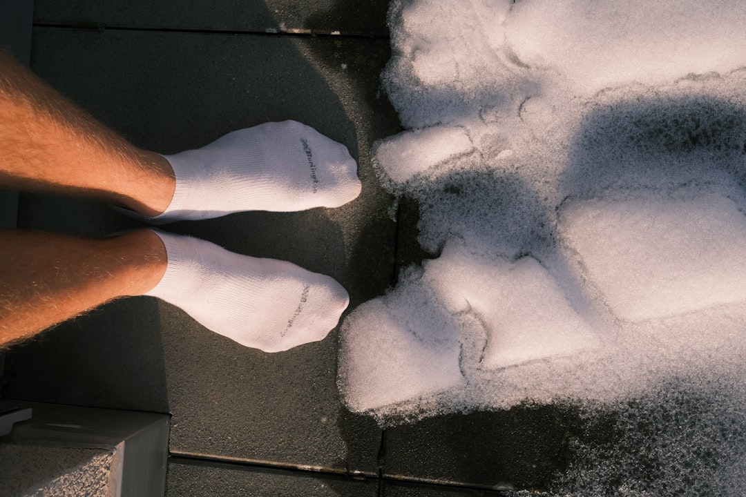 a person standing on a sidewalk covered in snow