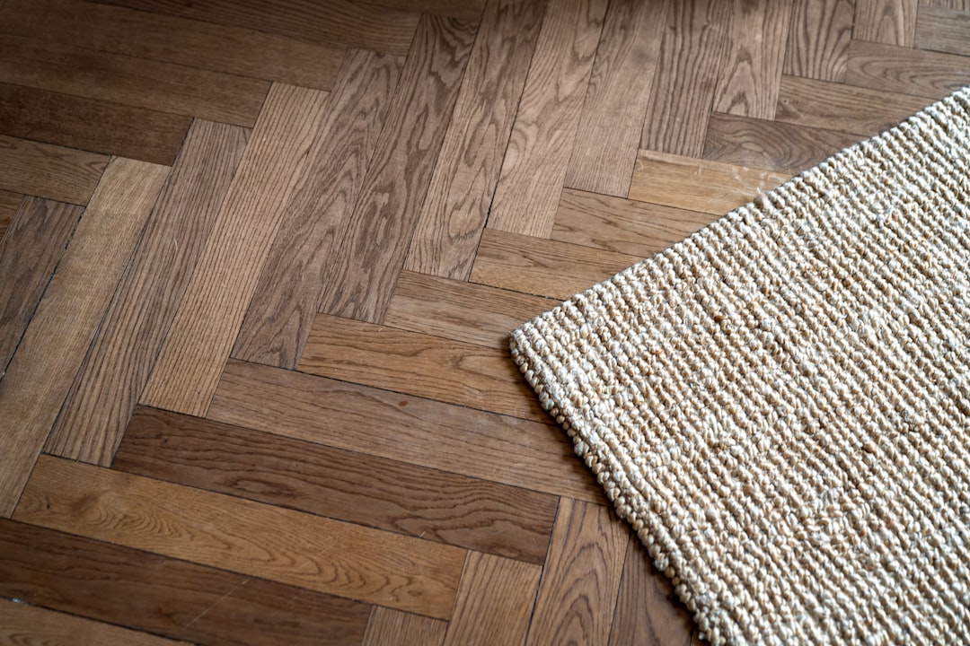 A close up of a rug on a wooden floor