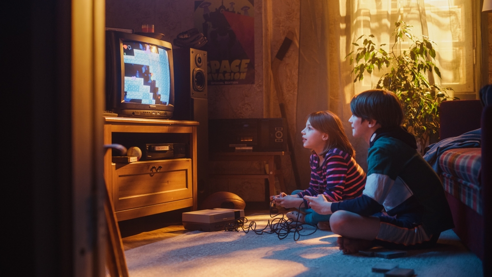 two young children play video game