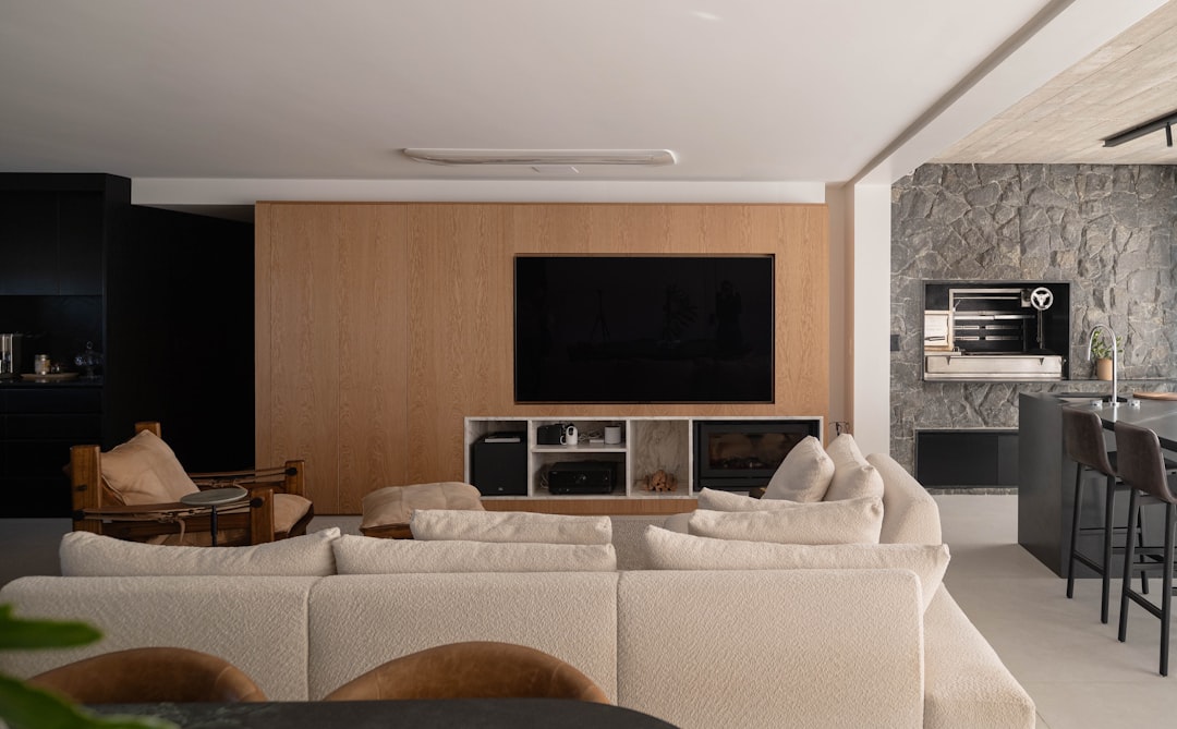 Modern living room with large sectional and stone accent wall.