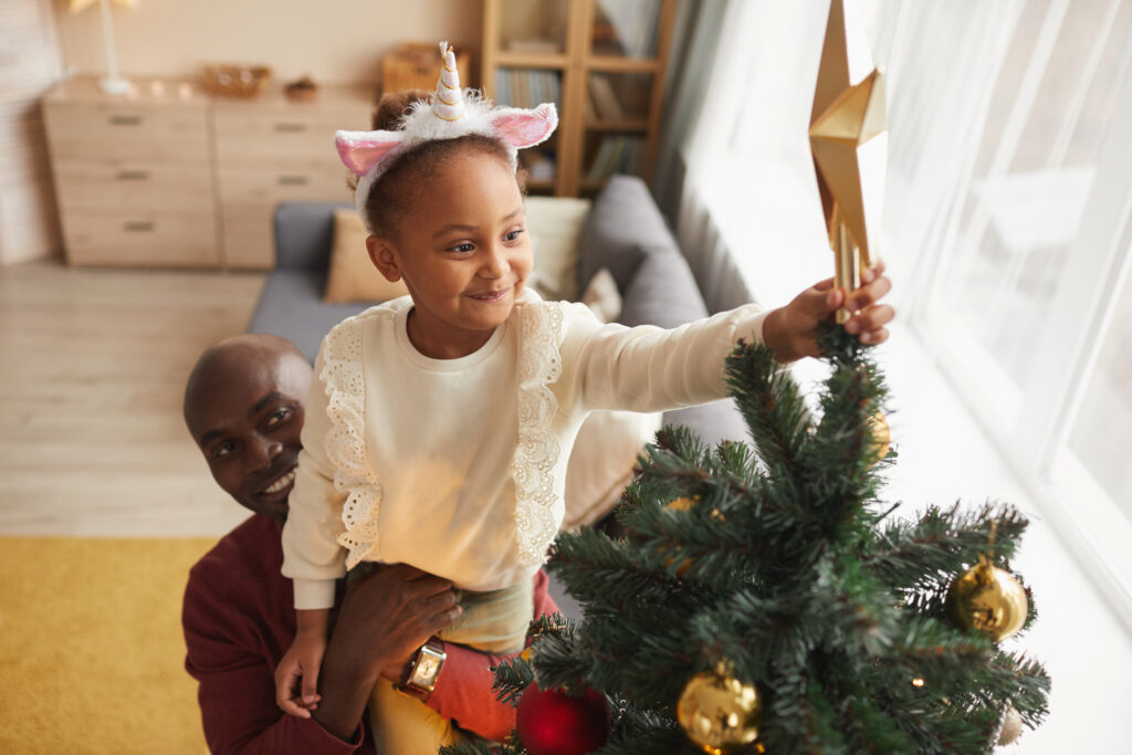 putting a topper on the Christmas tree