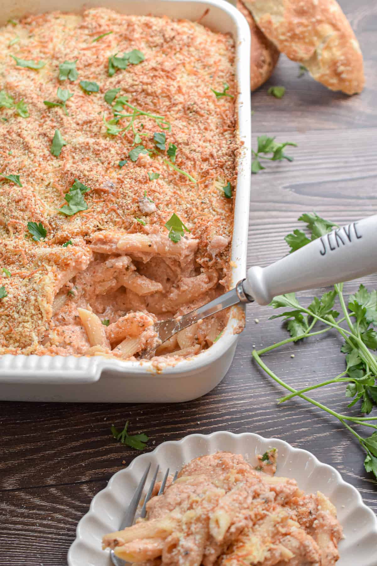 A spoon with the word serve on it is in the baking dish.