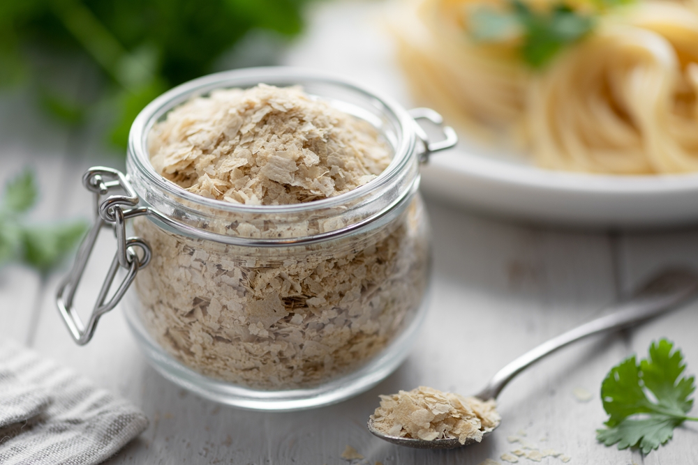 Nutritional yeast flakes in a glass jar