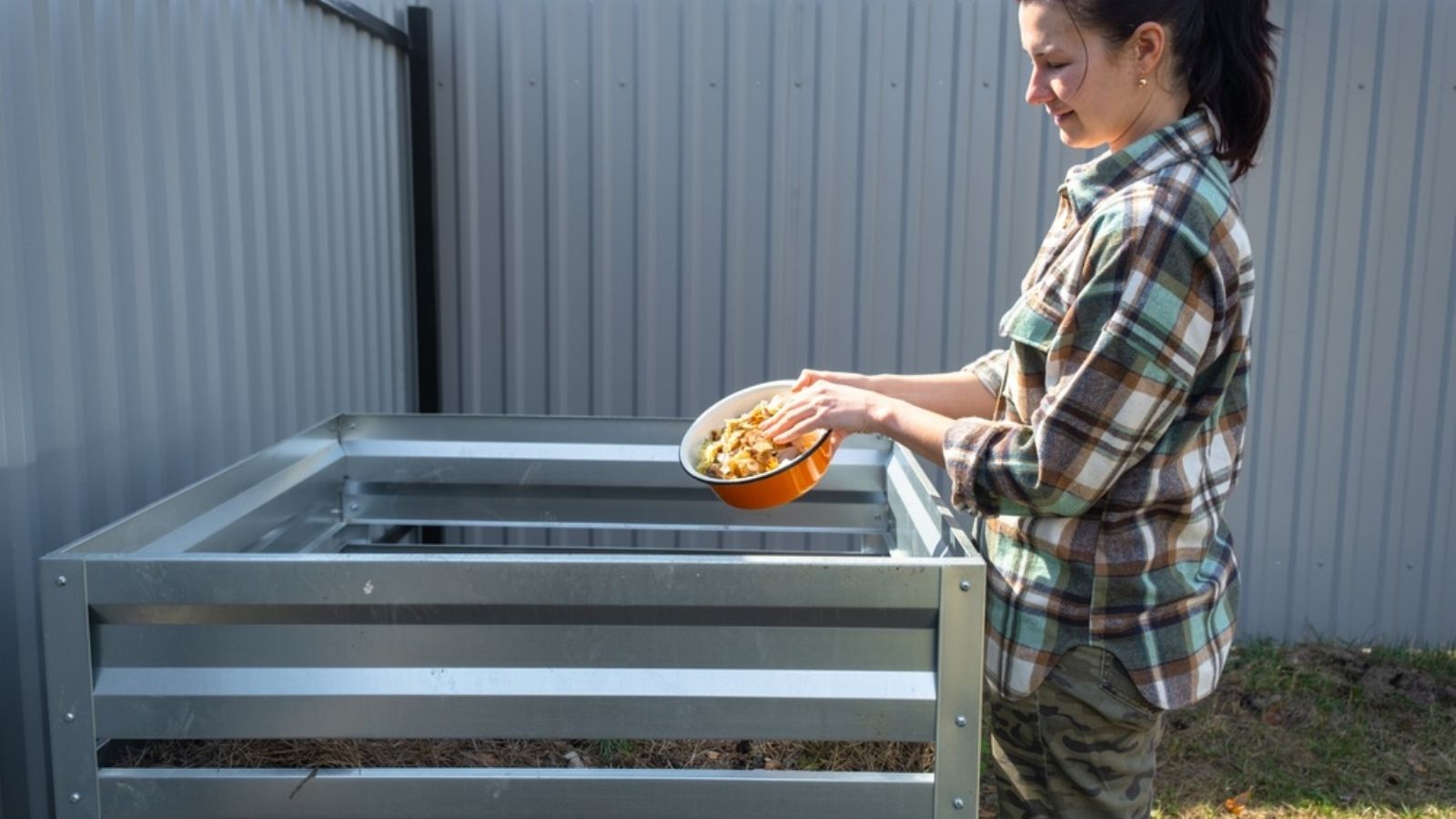 adding scraps to compost heap