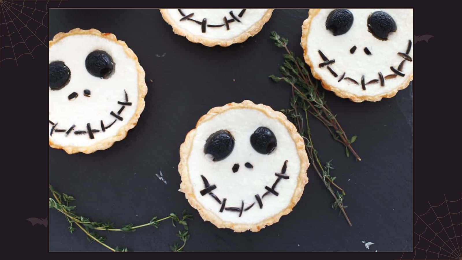 Savory ricotta tarts decorated with Jack Skellington faces made from black olives