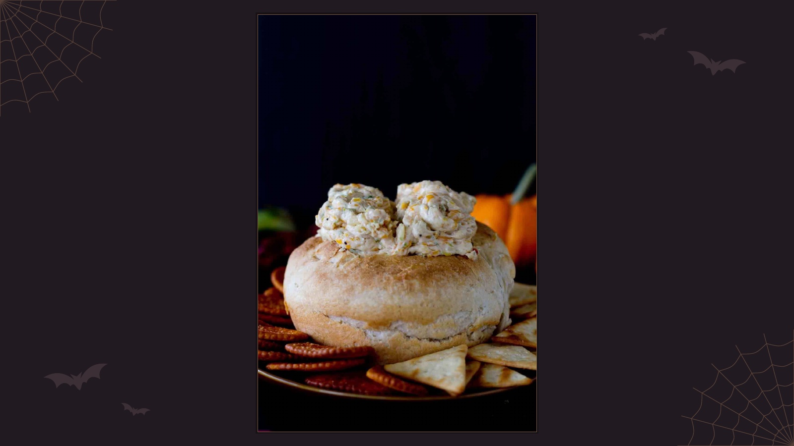 Halloween cheese dip shaped into a pair of brains and served in a hollowed bread bowl