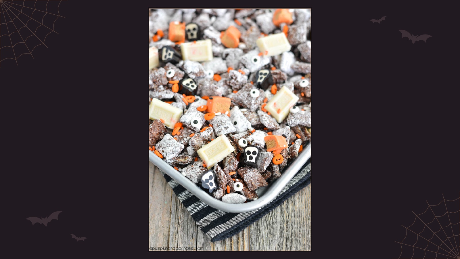 Chocolate peanut butter muddy buddies mixed with orange Halloween candy and edible eyeballs