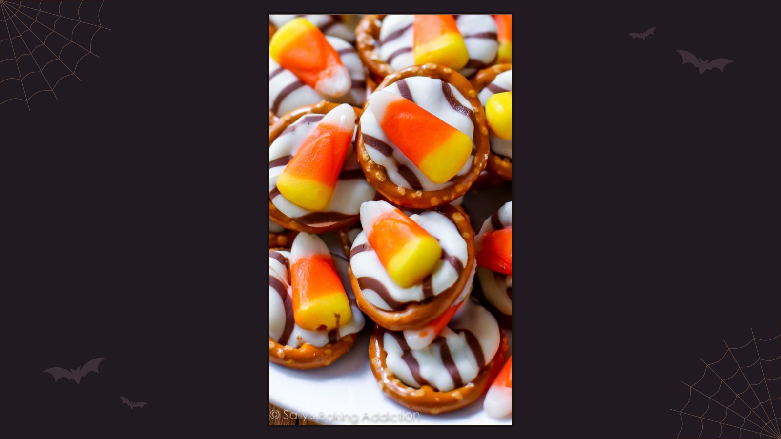 Small pretzels topped with melted striped chocolate kisses and candy corn
