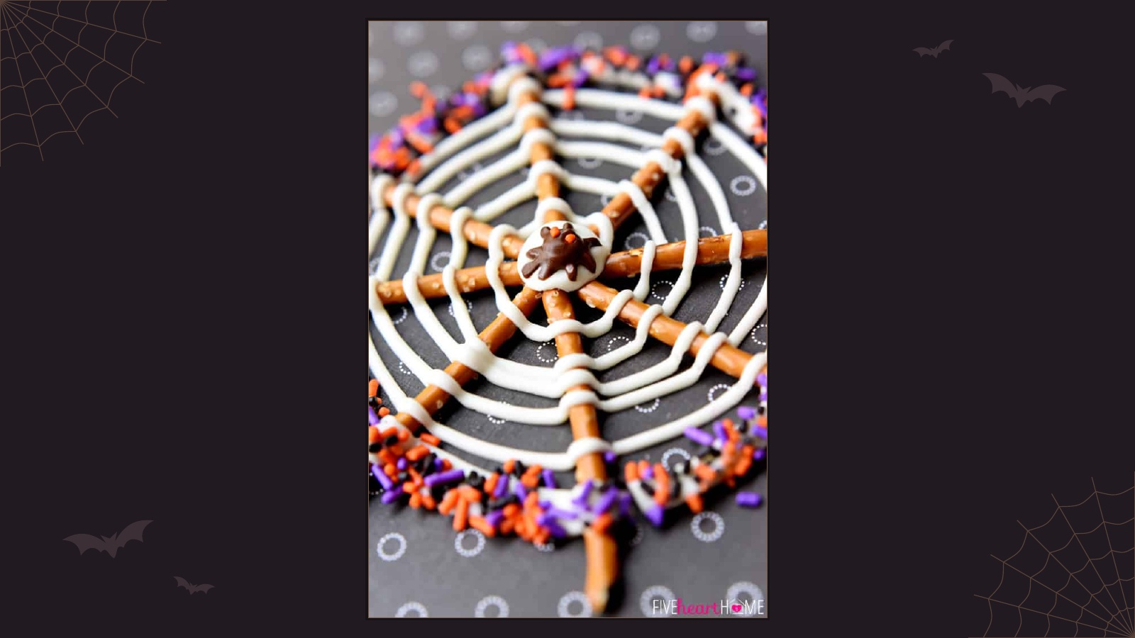 Spiderweb made from pretzel sticks and white chocolate with Halloween sprinkles