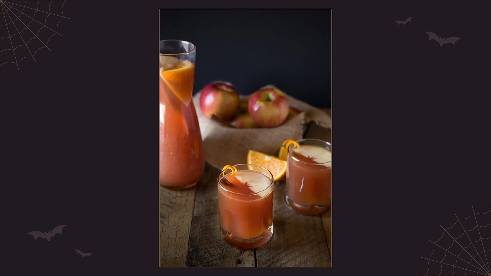 Sparkling fall apple punch with apple slices, orange and cinnamon garnish