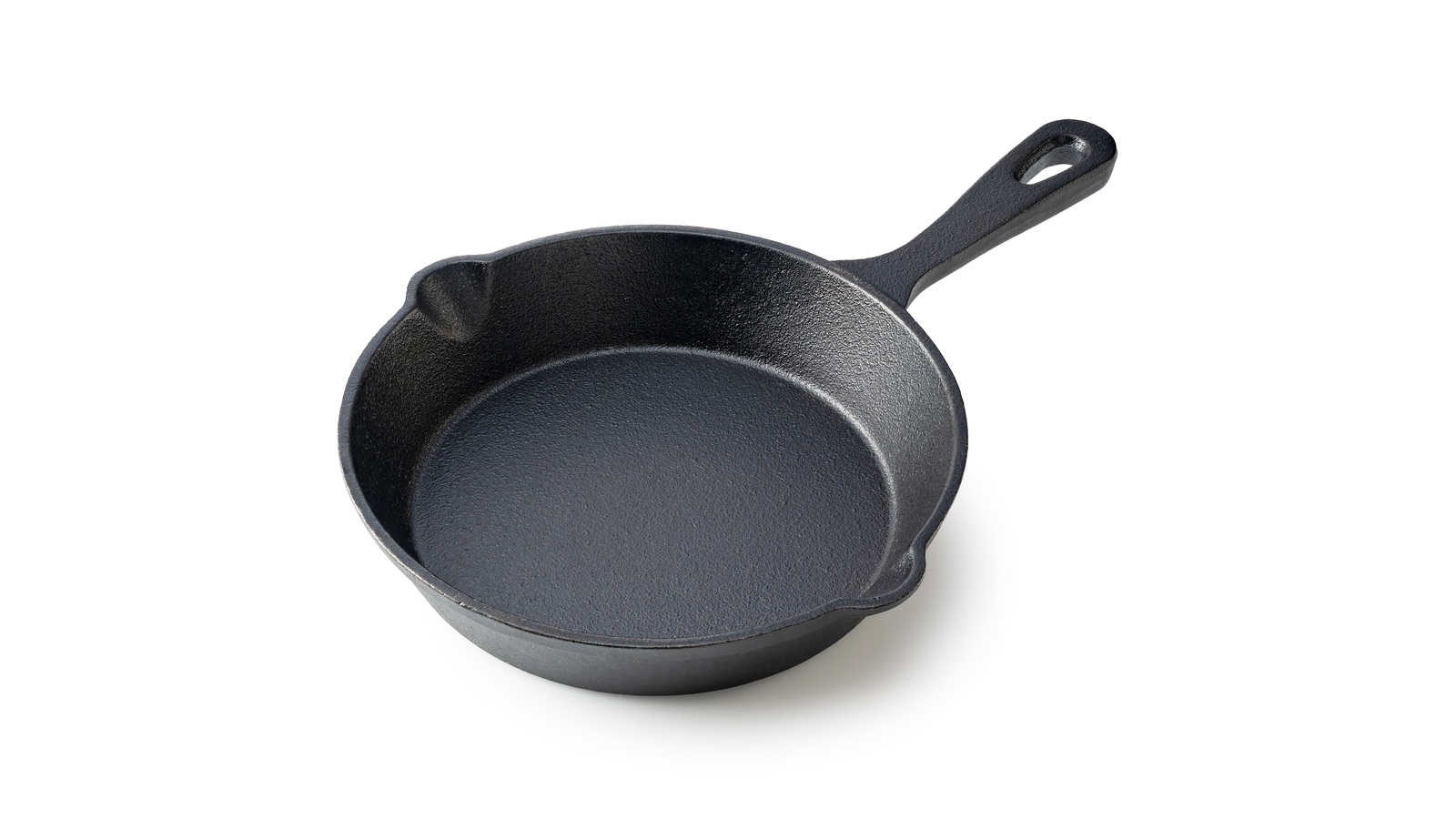 An empty cast-iron skillet showing its rim, sides and handle
