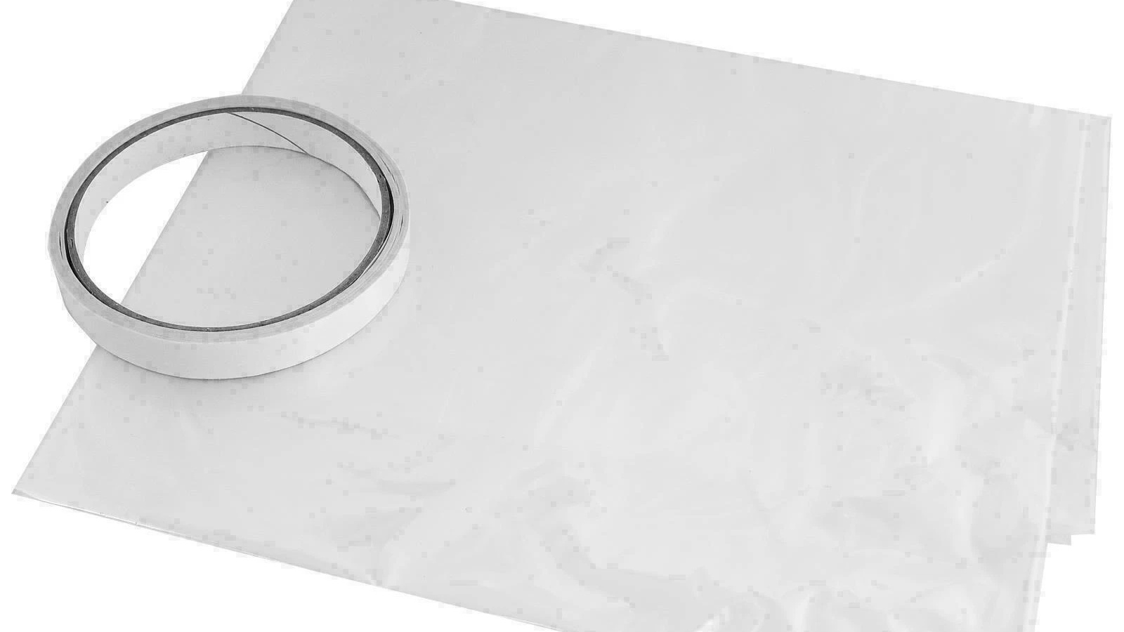 Folded clear window insulation film beside a roll of double-sided fixing tape