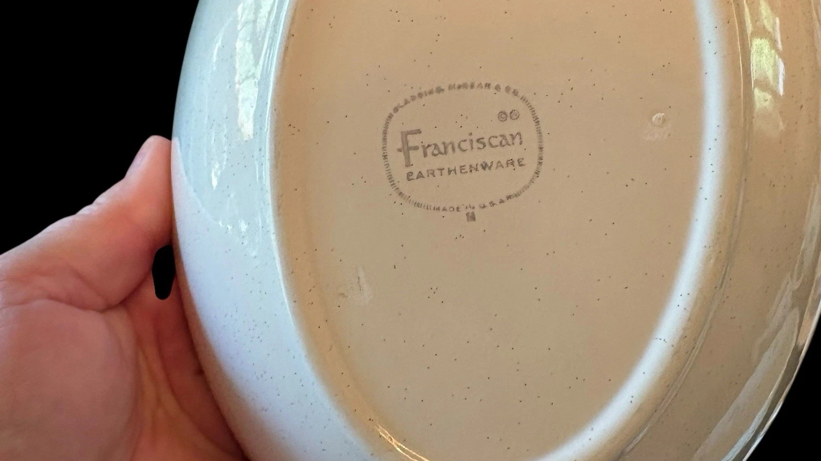 Underside of a Franciscan dish showing the rounded rectangular Franciscan Earthenware Made in USA backstamp.