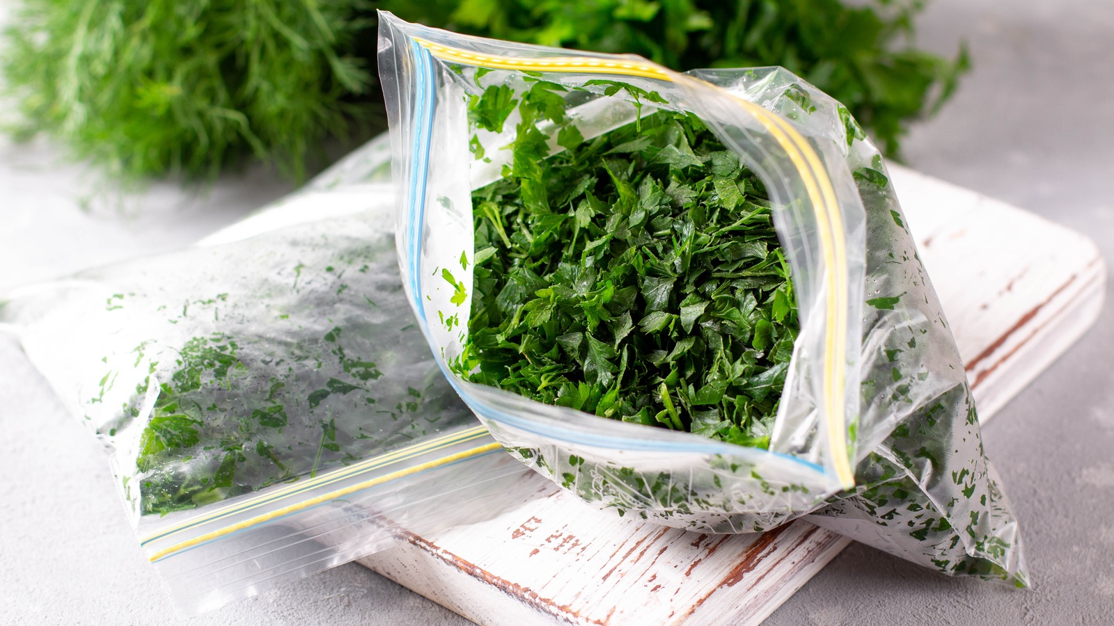 Chopped frozen parsley and dill in resealable freezer bags