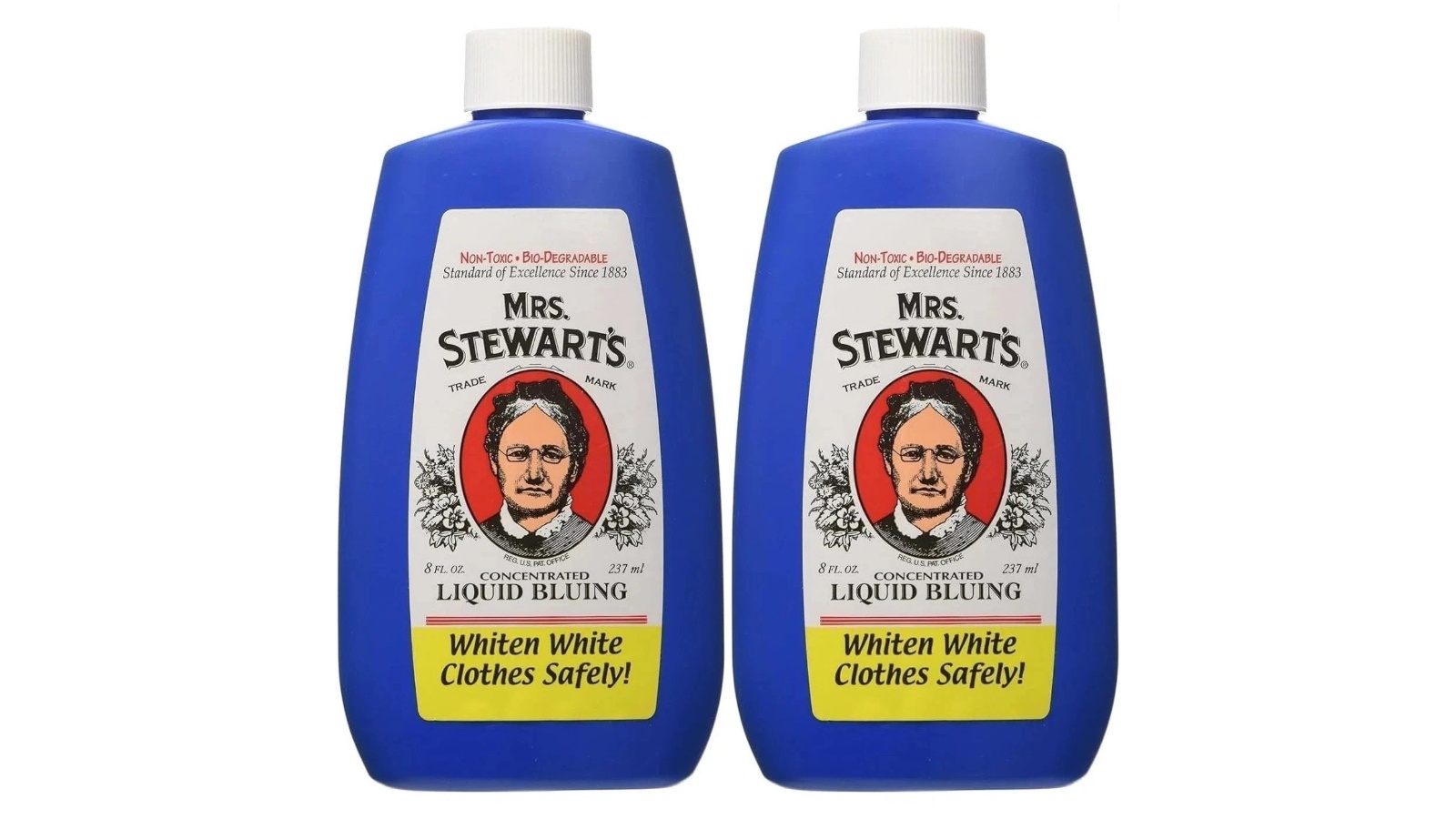 Two blue bottles of Mrs Stewarts concentrated liquid laundry bluing with white caps