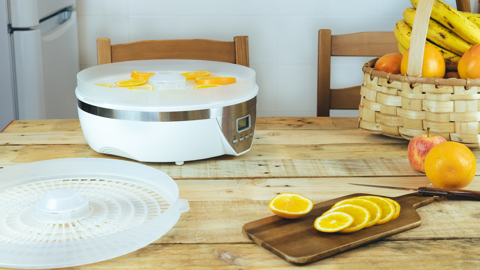 Countertop food dehydrator beside sliced citrus on a cutting board