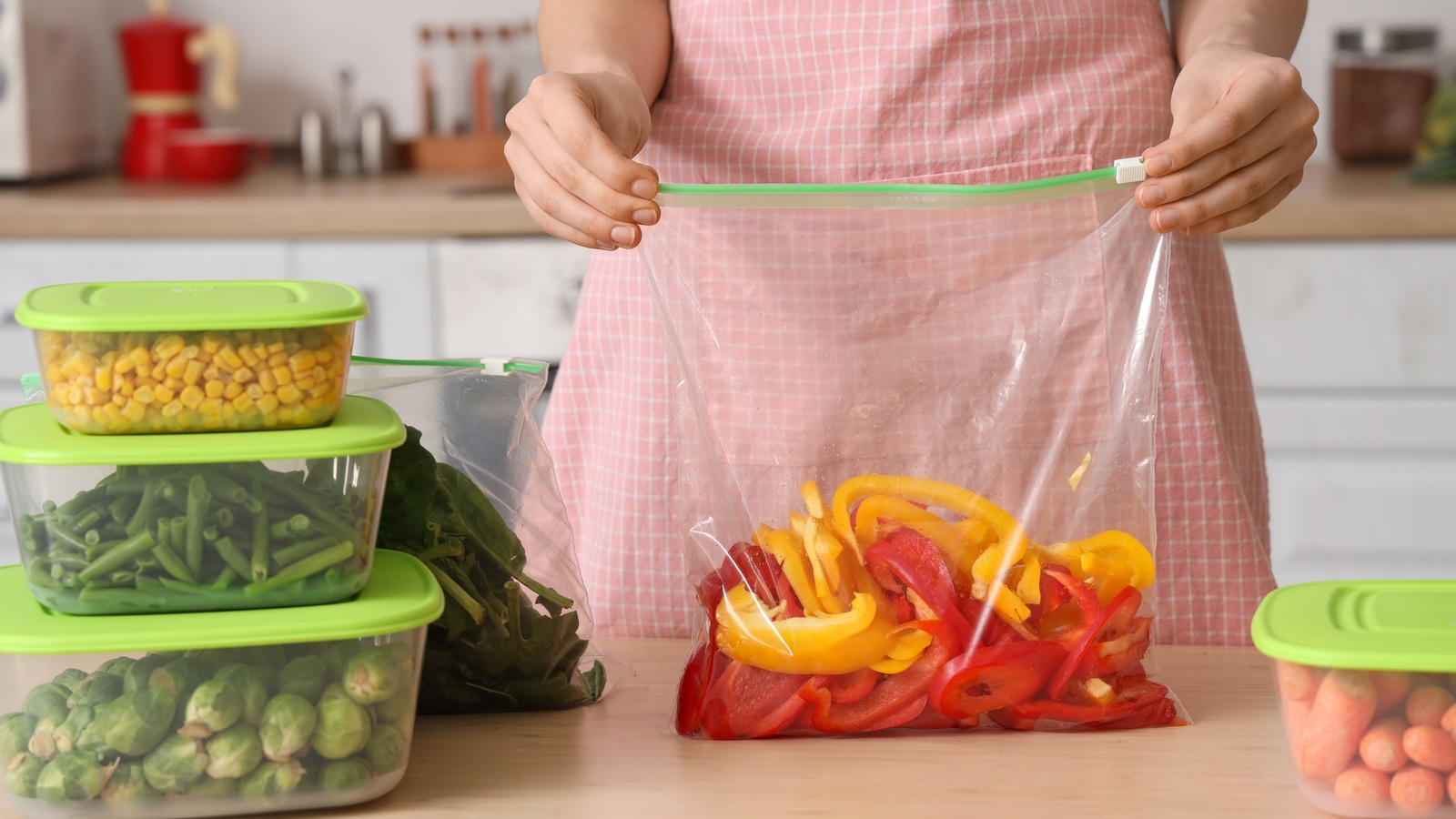 Woman holding a resealable bag containing red and yellow pepper strips