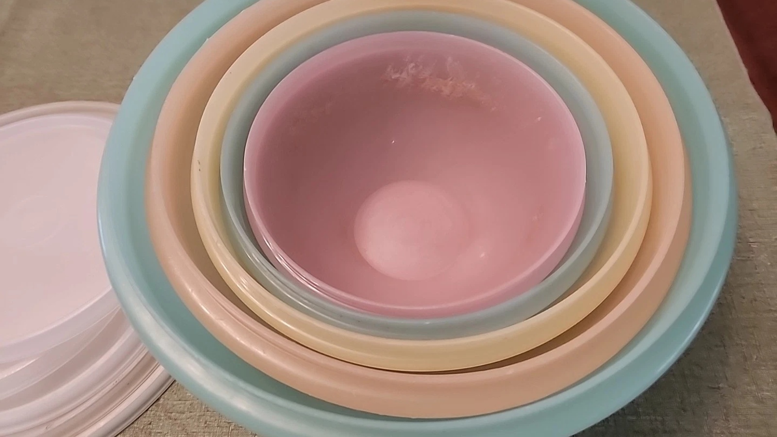 Close overhead view of the pink, blue, yellow, peach and green rims of nested Wonderlier bowls.