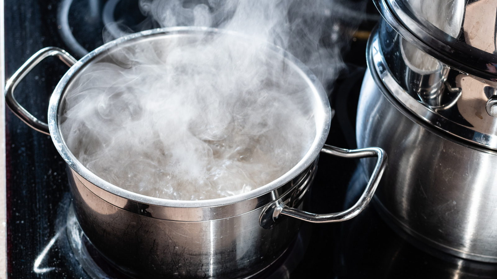 Steam rising from boiling water in a stainless-steel pot