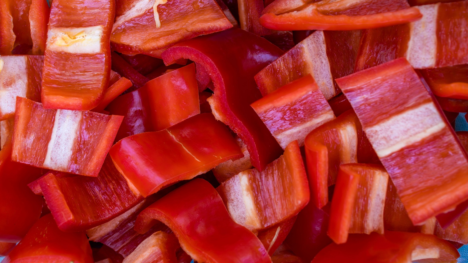 Close view of fresh uncooked red bell pepper pieces